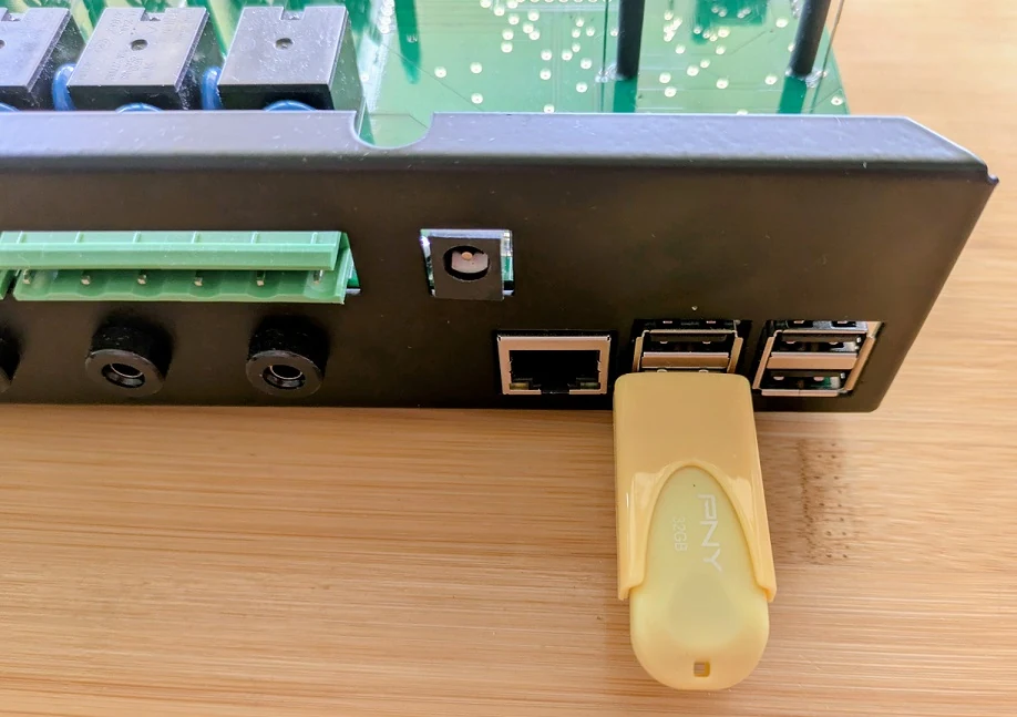 A USB pen inserted into one of the Dragonfly's USB ports on the outside of the enclosure, next to the network socket