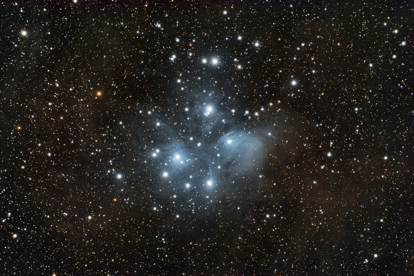 The Pleiades cluster, M45: blue stars wrapped in a veil of dust