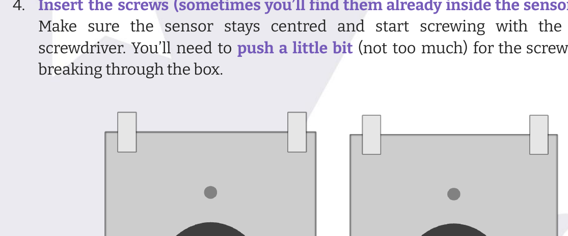 Screws being inserted into the sensor mounting holes, before and after screwing through