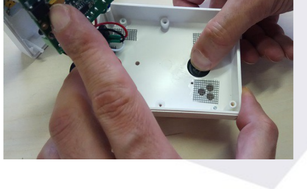 Removing the protective lid from the back of the box with finger pressure